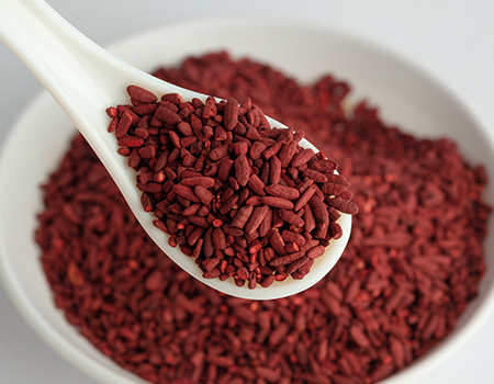red yeast rice on a spoon